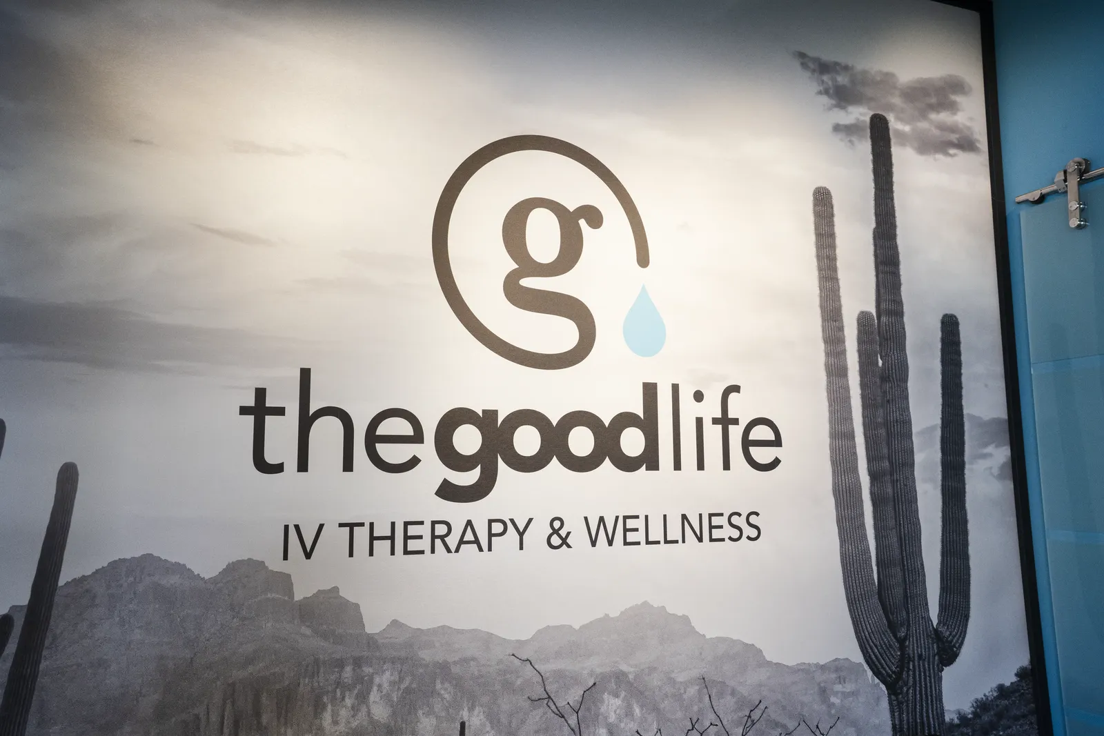 The lobby wall: the Good Life logo over a black and white desert